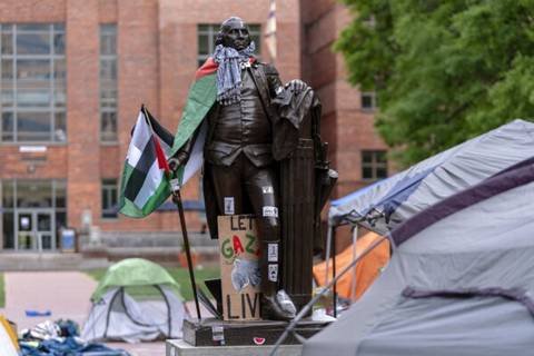 A statue of George Washington draped in a Palestinian flag and a keffiyeh is seen at George Washington University as students demonstrate on campus during a pro-Palestinian protest over the Israel-Hamas war on Friday, April 26, 2024, in Washington. (AP Photo/Jose Luis Magana)